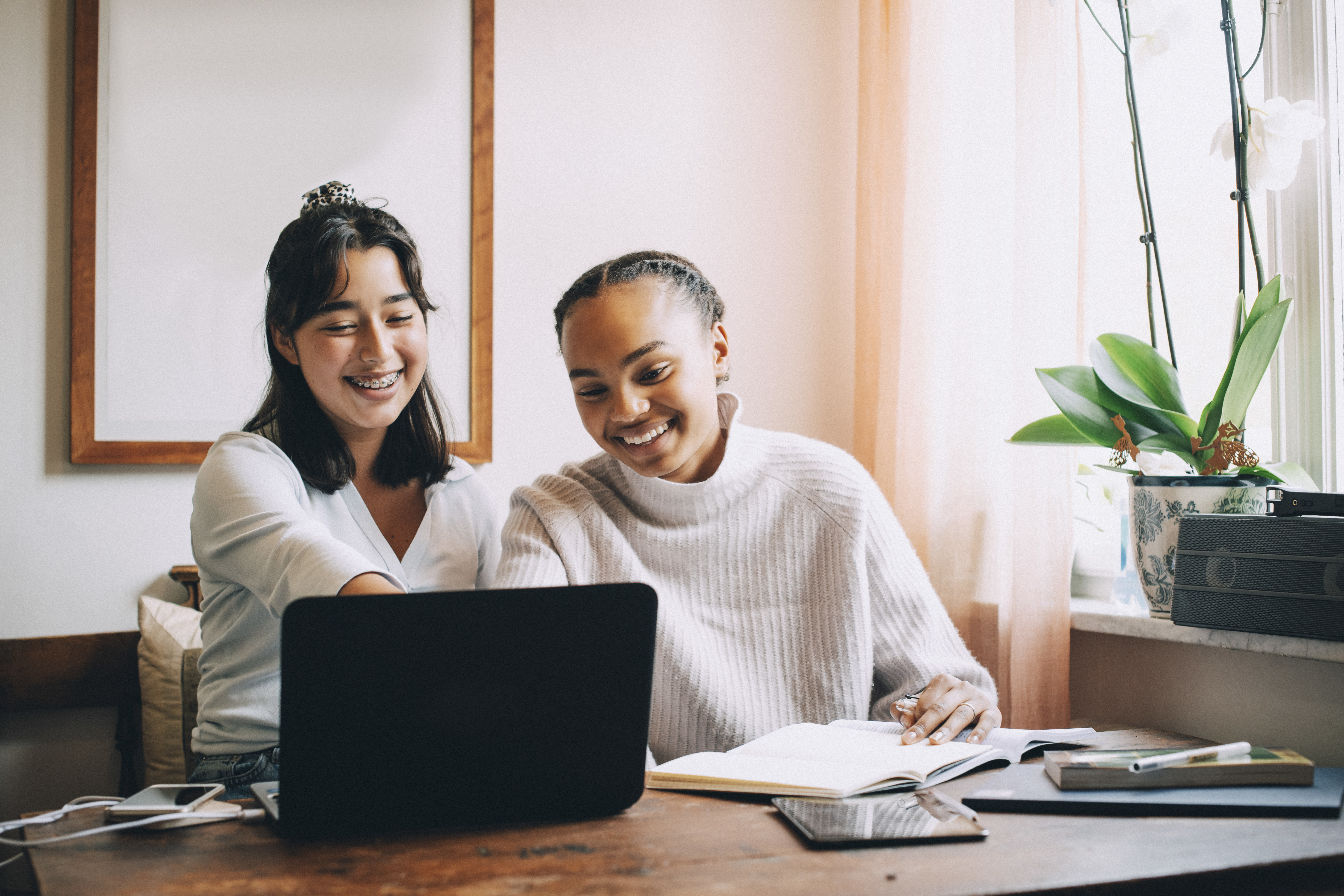 Two female students working together at one laptop